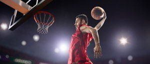 A basketball player dunking