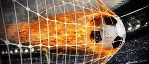 Football on fire hitting the back of the net