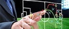 A hand clicking on a football pitch, developing tactics