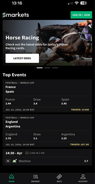 Smarkets app homepage featuring a horse racing promotion and top World Cup football events with traded volumes