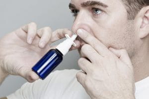 Man using a nasal spray