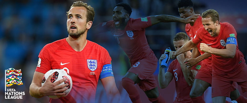 Harry Kane standing with the ball, players celebrating in the backgtound