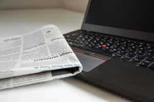A laptop and newspaper