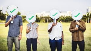 Four people with tick signs on their face