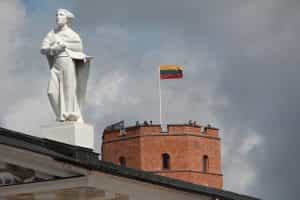 Lithuanian flag on a building with a statue