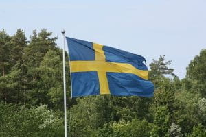 Swedish flag in front of a forest