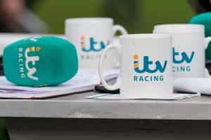 Microphone and cups branded with ITV Racing logos.