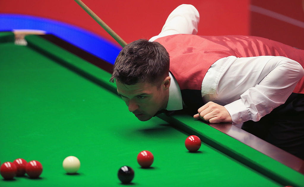 Snooker player Michael Holt planning his next shot at the table.