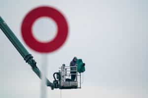A racecourse cameraman captures the action from a cherry picker at Kempton Park.
