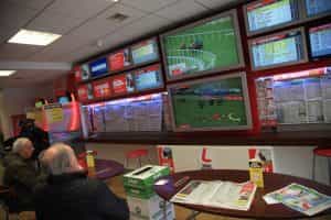 The screens inside a Ladbrokes betting shop displaying the latest odds and live action.