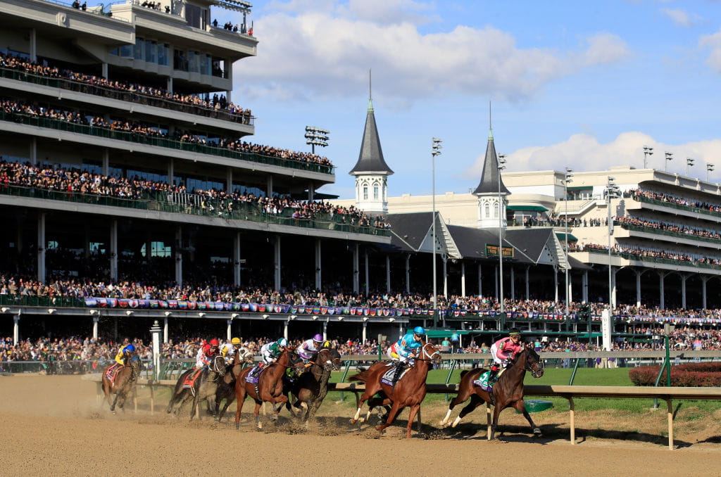 Horses racing before the Churchill Downs grandstand.