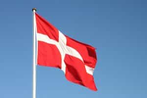 A picture of the Danish flag blowing in the wind.