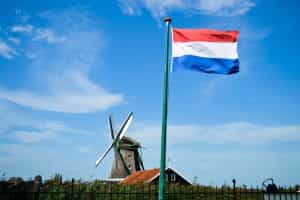 A picture of a windmill and the Netherlands flag.