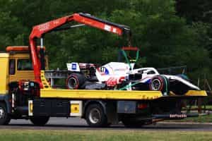 Mick Schumacher’s crashed Haas Formula 1 is taken away on a flat-bed truck.