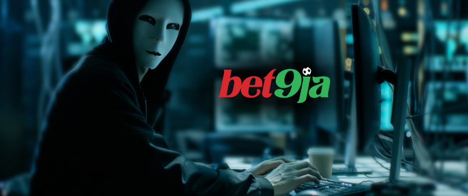 A picture of a hacker wearing a mask with the Bet9ja logo displayed on the computer screen