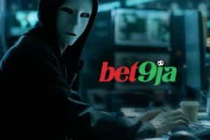 A picture of a hacker with the Bet9ja logo displayed on the computer screen
