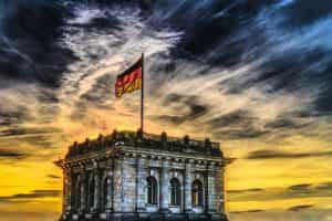 A picture of the Bundestag with a German flag flying from it.