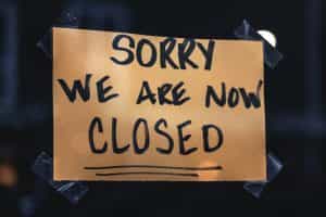 A shop sign with the words, “sorry, we are closed”