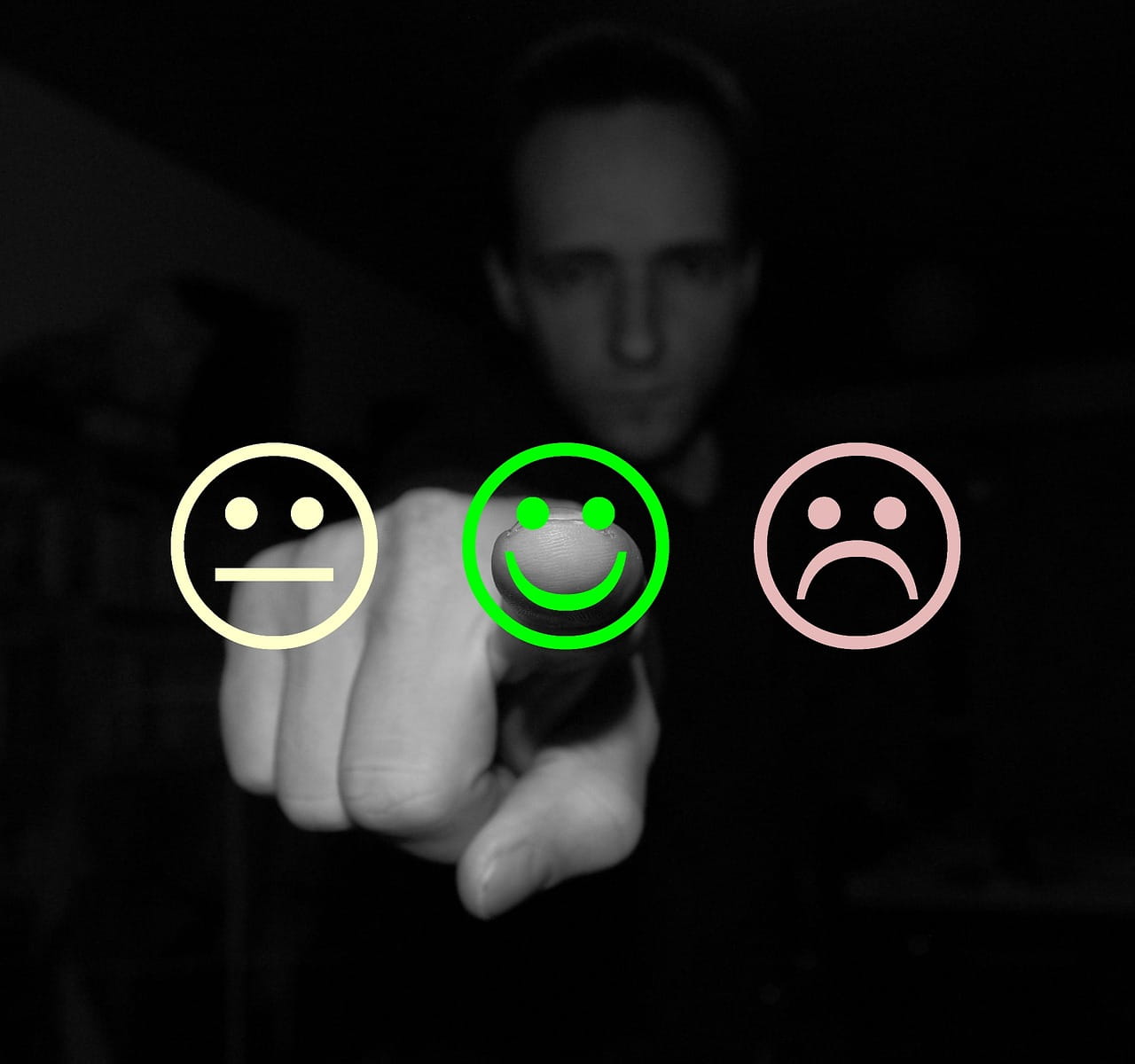picture of a man completing onscreen feedback and three faces depict available choices.