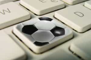 A picture of a keyboard with a football icon on it to depict a fantasy football competition.