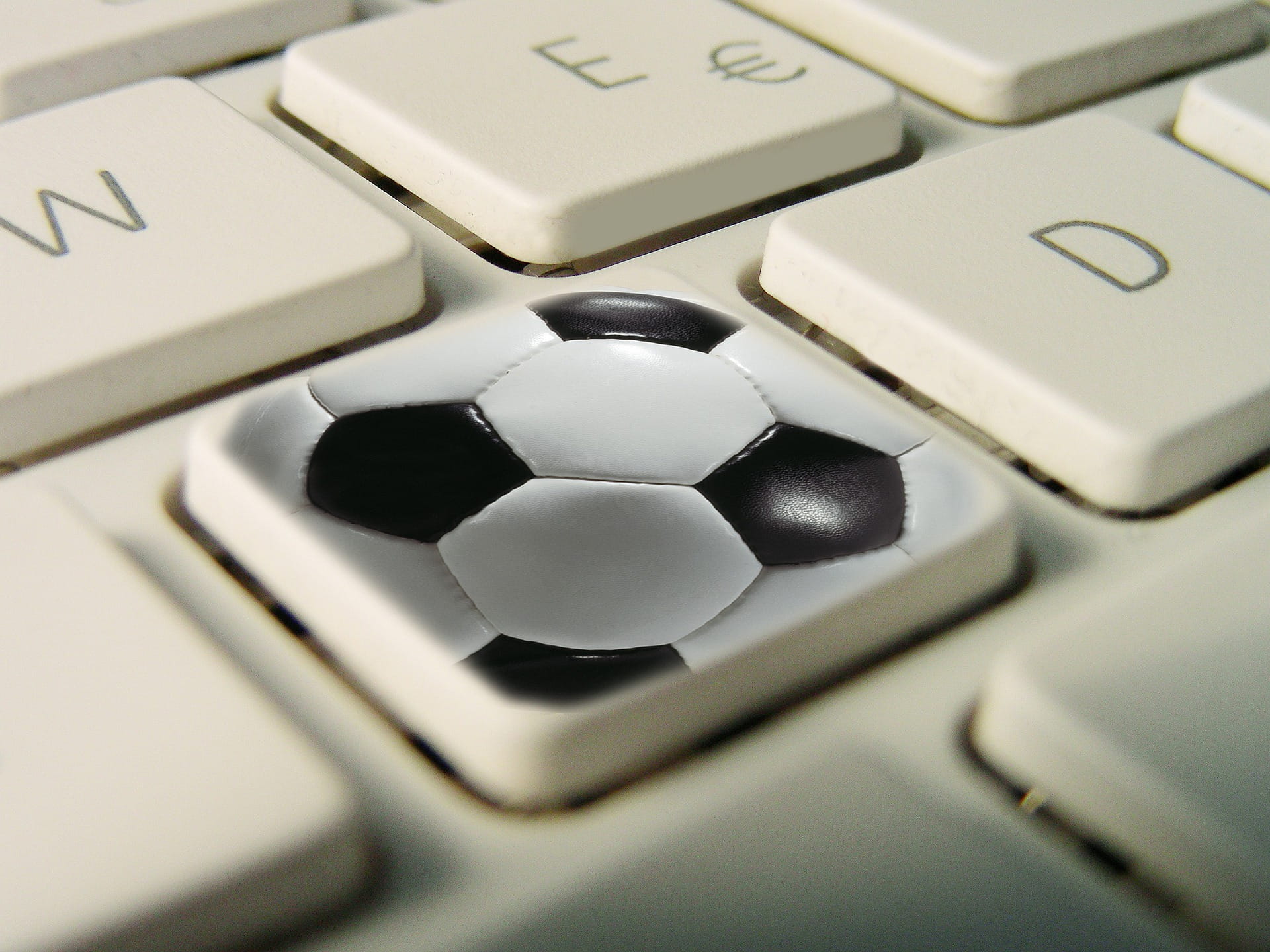 A picture of a keyboard with a football icon on it to depict a fantasy football competition.