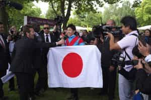 Jockey Yutaka Take with the Japanese flag at Longchamp racecourse, 2013.
