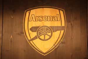 Arsenal logo on wood a background