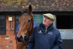 Paul Nicholls poses with Bravemansgame at his stables.