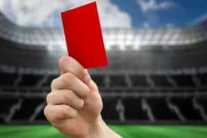 A picture of a referee holding up a red card