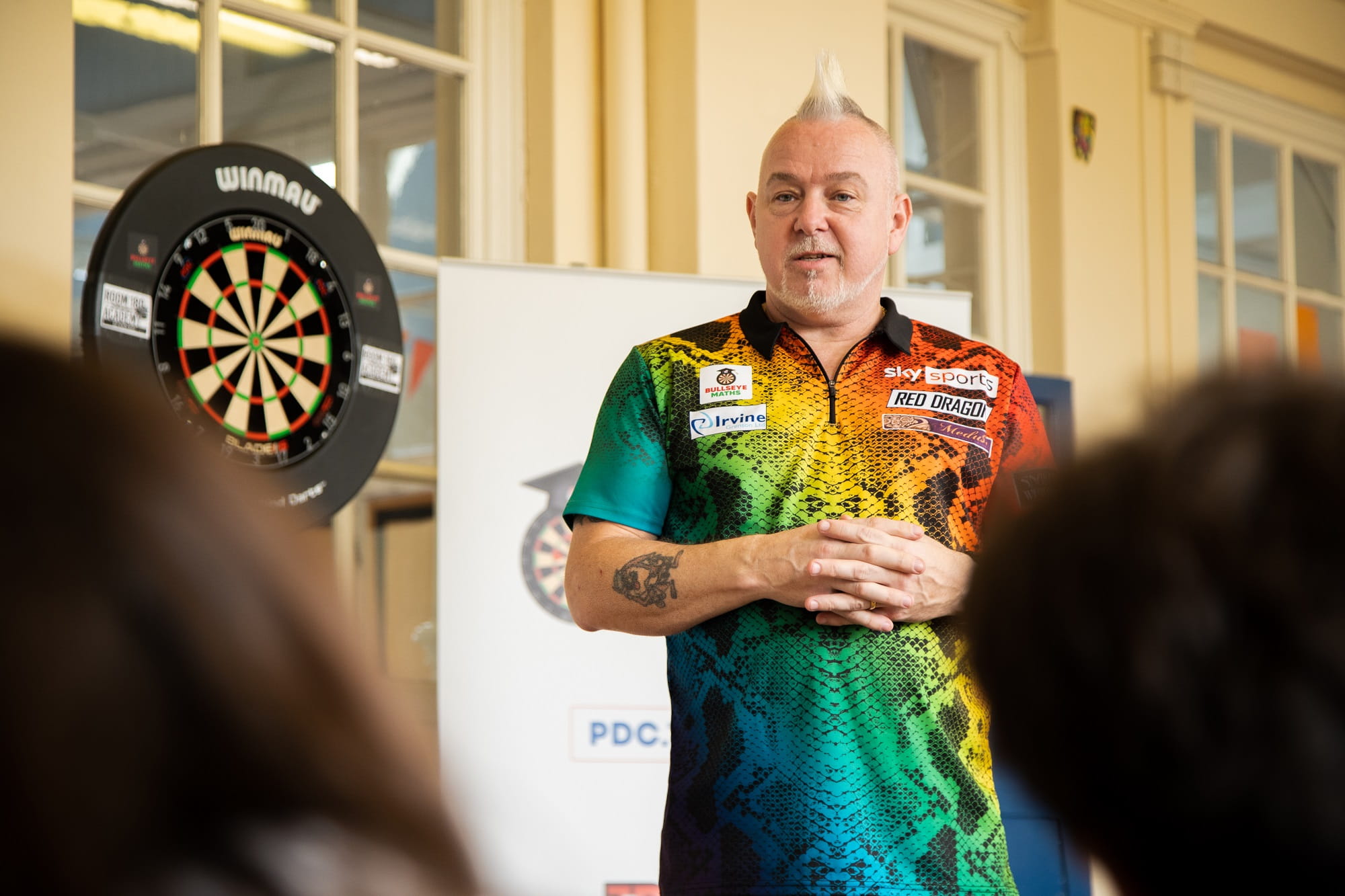 Peter Wright visiting schoolchildren to help teach them maths via darts play.