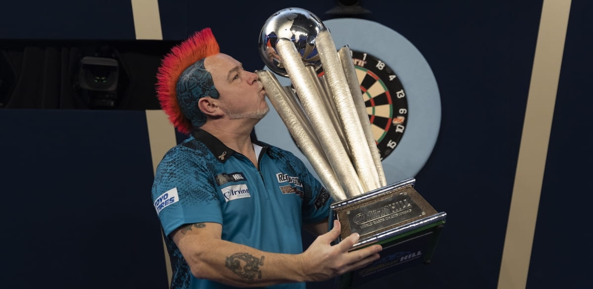 Peter Wright kisses his 2022 World Darts Championship trophy.