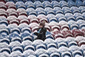 A young fan plays with snow inside the stadium prior at Turf Moor on November 28, 2021.
