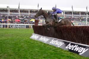 Paul Townend, riding Energumene, clears the last to win the Queen Mother Champion Chase.