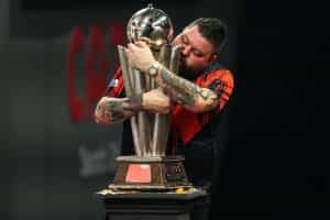 Mick Smith embraces his 2023 World Darts Championship trophy.