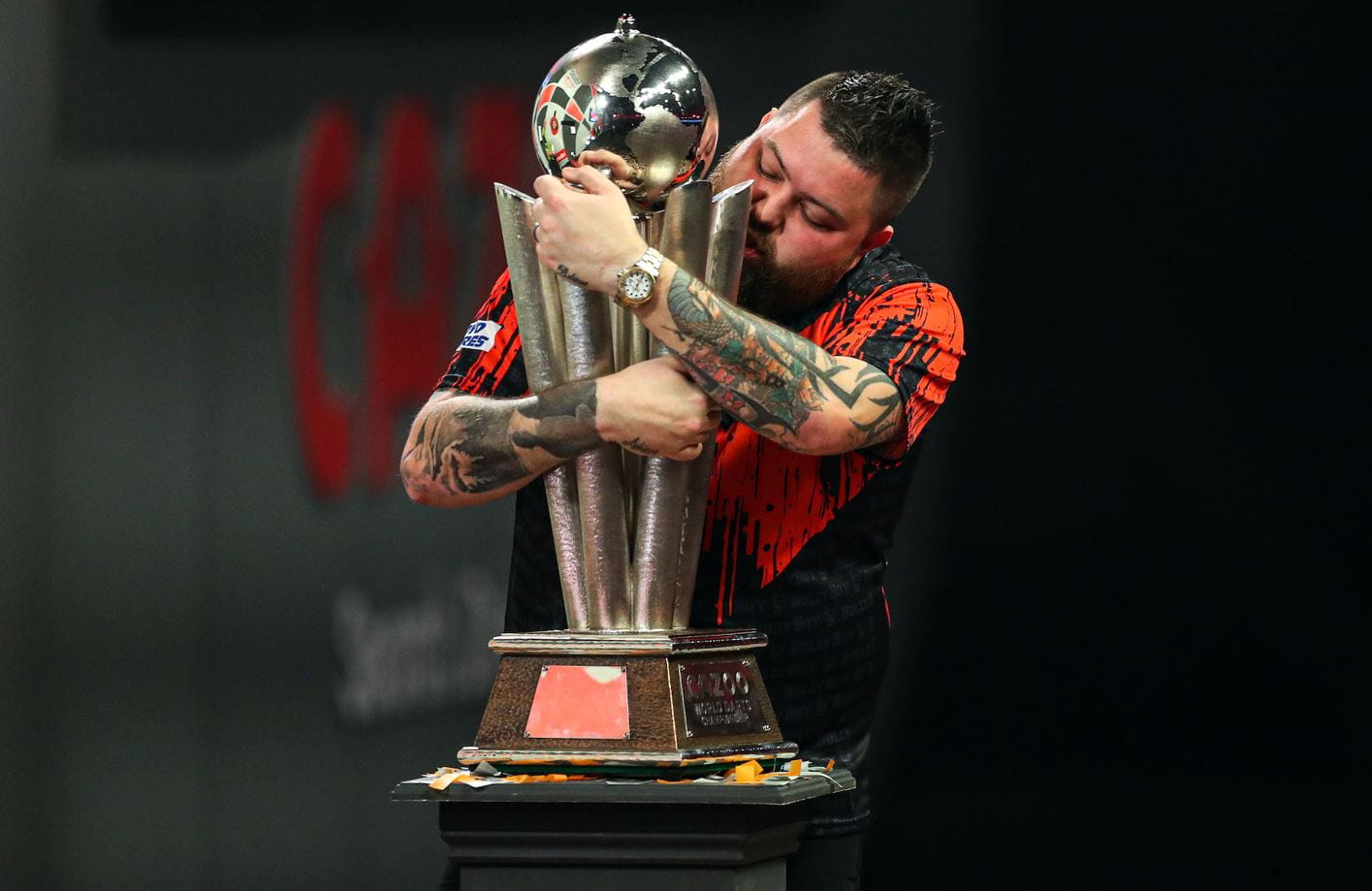 Mick Smith embraces his 2023 World Darts Championship trophy.