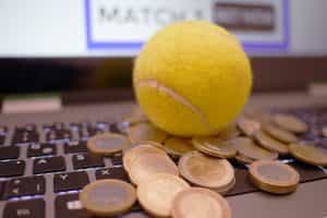 A picture of a tennis ball on a computer with money also shown