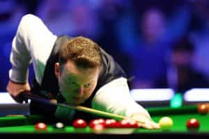 Snooker player Shaun Murphy takes a shot.