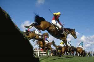 A general view of the field jumping a fence during the 1989 Grand National
