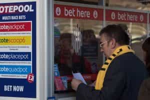 A man places his bets at a Cheltenham Tote window during the Festival meeting.