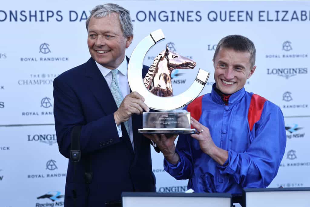 Tom Marquand and William Haggas receive a winner’s trophy at Royal Randwick Racecourse in 2023.