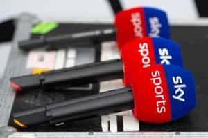 A row of three Sky Sports branded microphones.