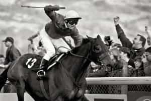 1994 Gold Cup winner, The Fellow, crosses the line ahead at the Cheltenham Festival.