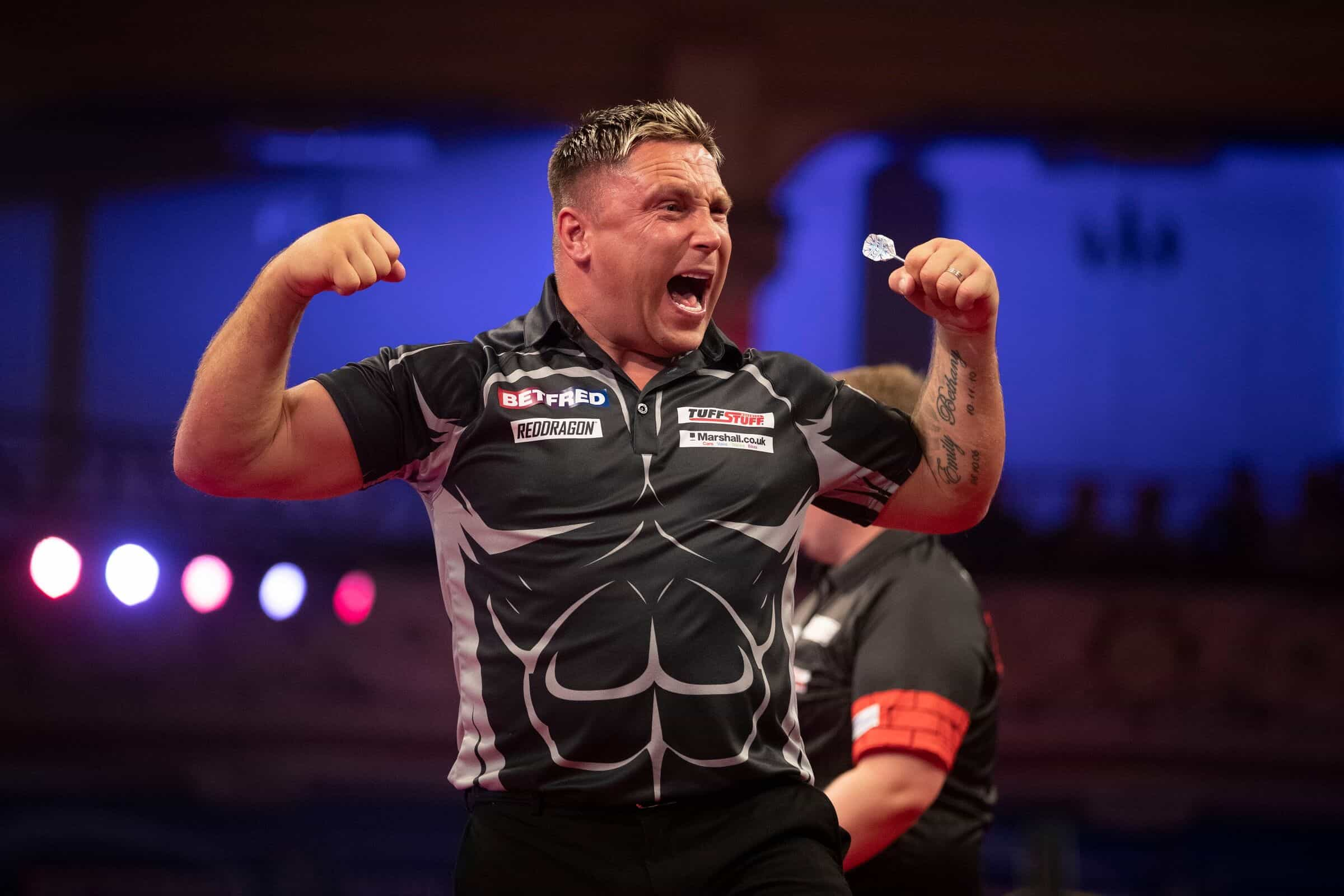 Darts player Gerwyn Price celebrates a match win on the oche.