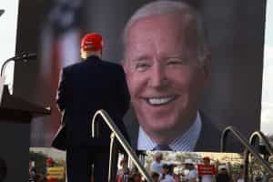 Former U.S. President Donald Trump watches a video of President Joe Biden playing during a 2022 rally in Miami.