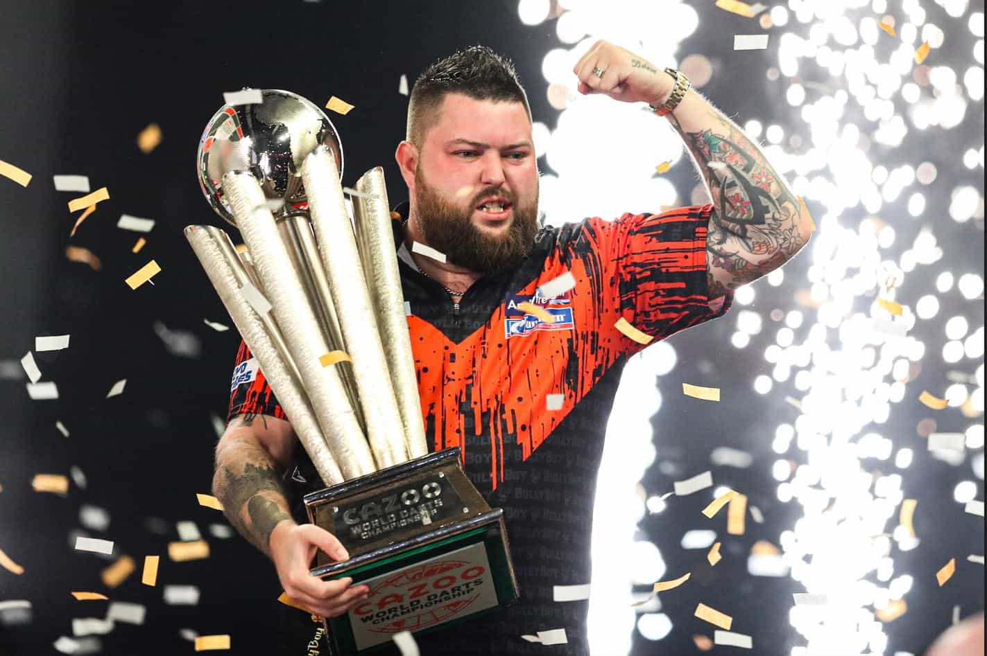 Michael Smith shows off his 2023 PDC World Darts Championship trophy. 