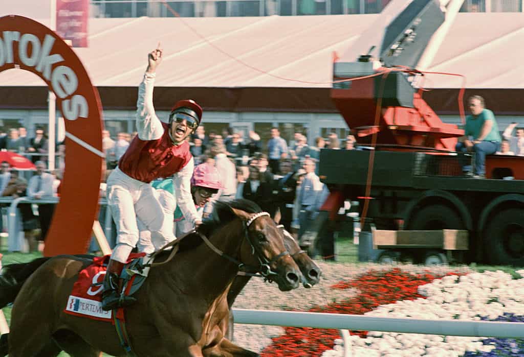Italian jockey Frankie Dettori celebrates crossing the line ahead in the 1996 St. Leger.
