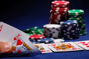 A picture of a poker table with cards being shown by a player