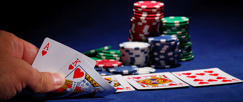 A picture of a poker table with cards being shown by a player