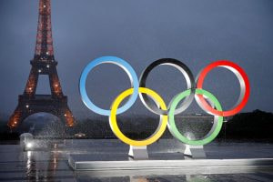 The Olympic rings displayed in Paris where the Eifel Tower can be seen in the backdrop.