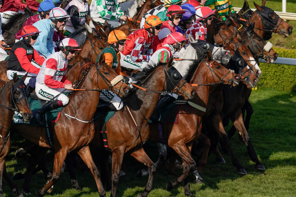 Runners line up at the start for the 2023 Randox Grand National Handicap Chase.